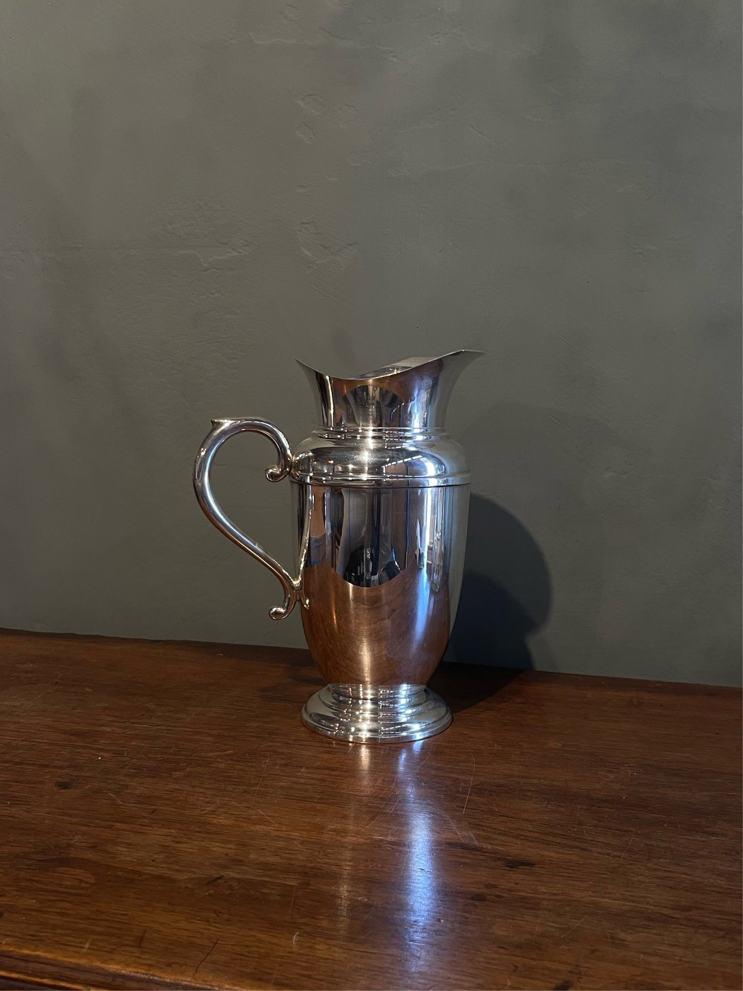 OVA NOV24 Antique silver plated Art Deco water pitcher jug with ovoid tapered body, helmet mouth, banding around the shoulder, and footed base