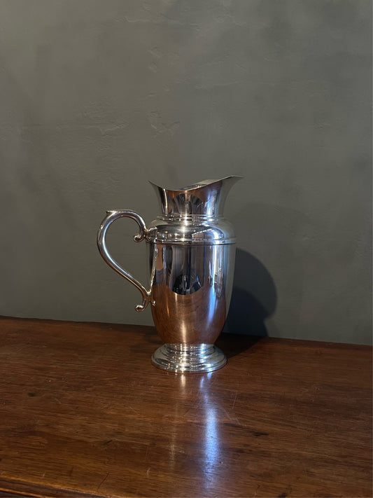 OVA NOV24 Antique silver plated Art Deco water pitcher jug with ovoid tapered body, helmet mouth, banding around the shoulder, and footed base